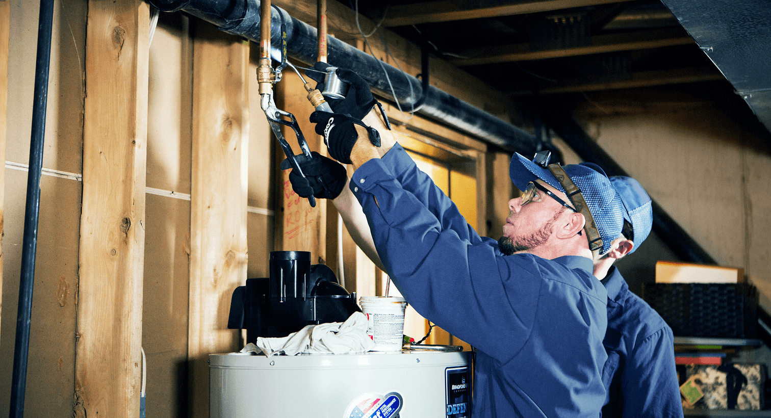 Two technicians working on pipes