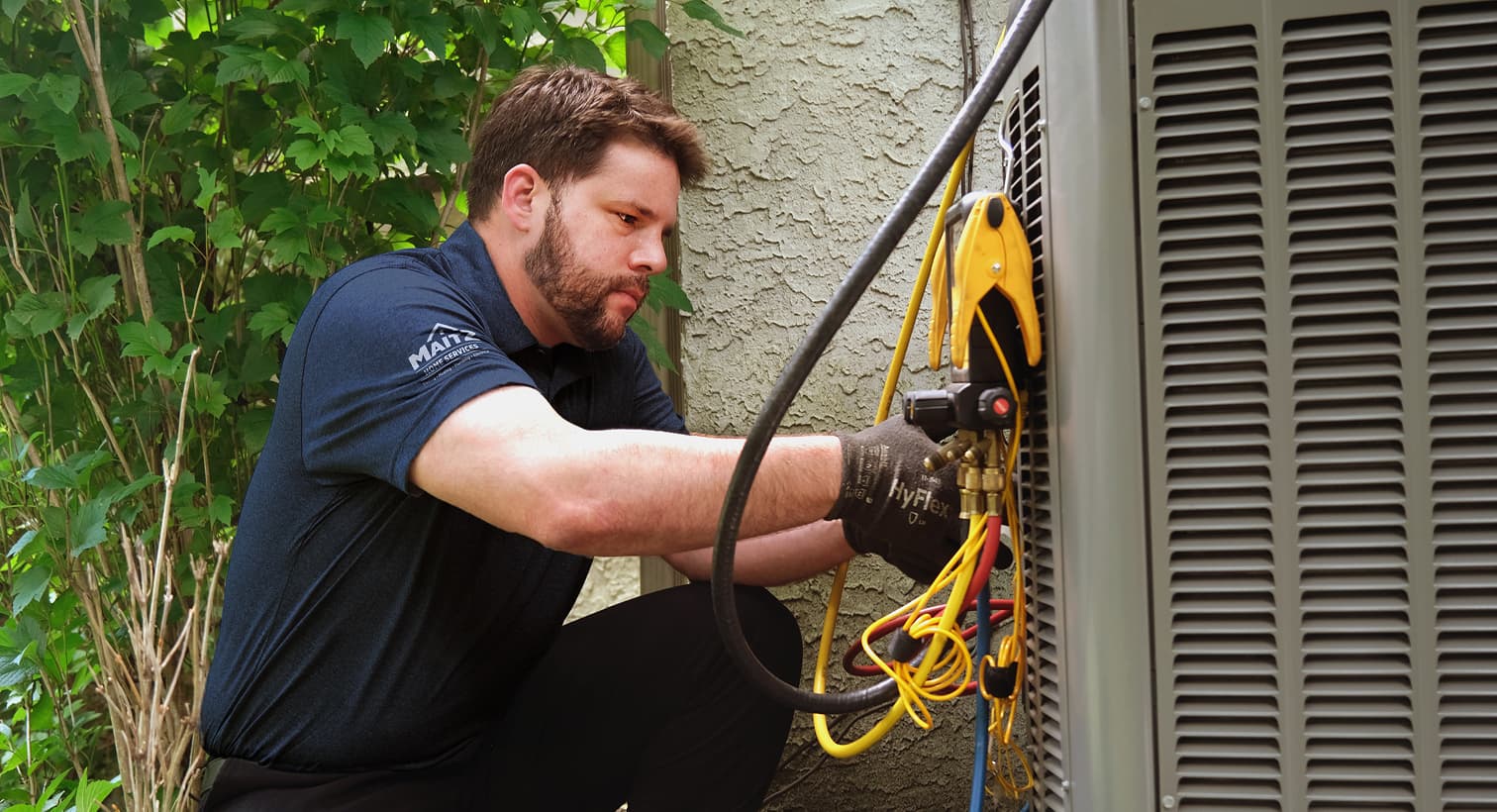 A professional Maitz HVAC technician inspecting an outdoor central air conditioning unit to provide residential AC repair and diagnostic services.